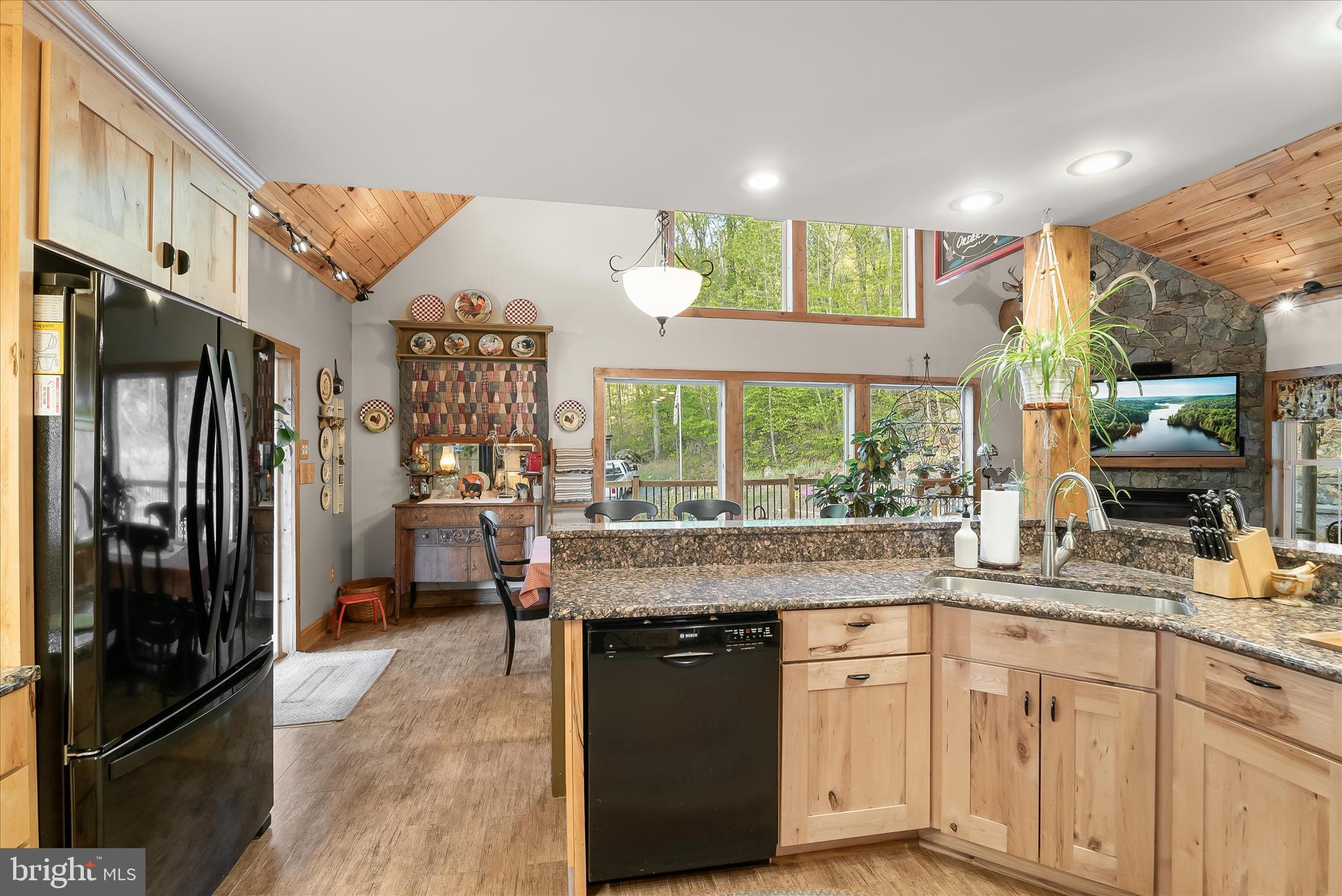4623 Fishers Hollow Road Myersville, MD 21773 - Photo 31 of 65 a kitchen with stainless steel appliances granite countertop a refrigerator a sink dishwasher a stove and white countertops with wooden floor