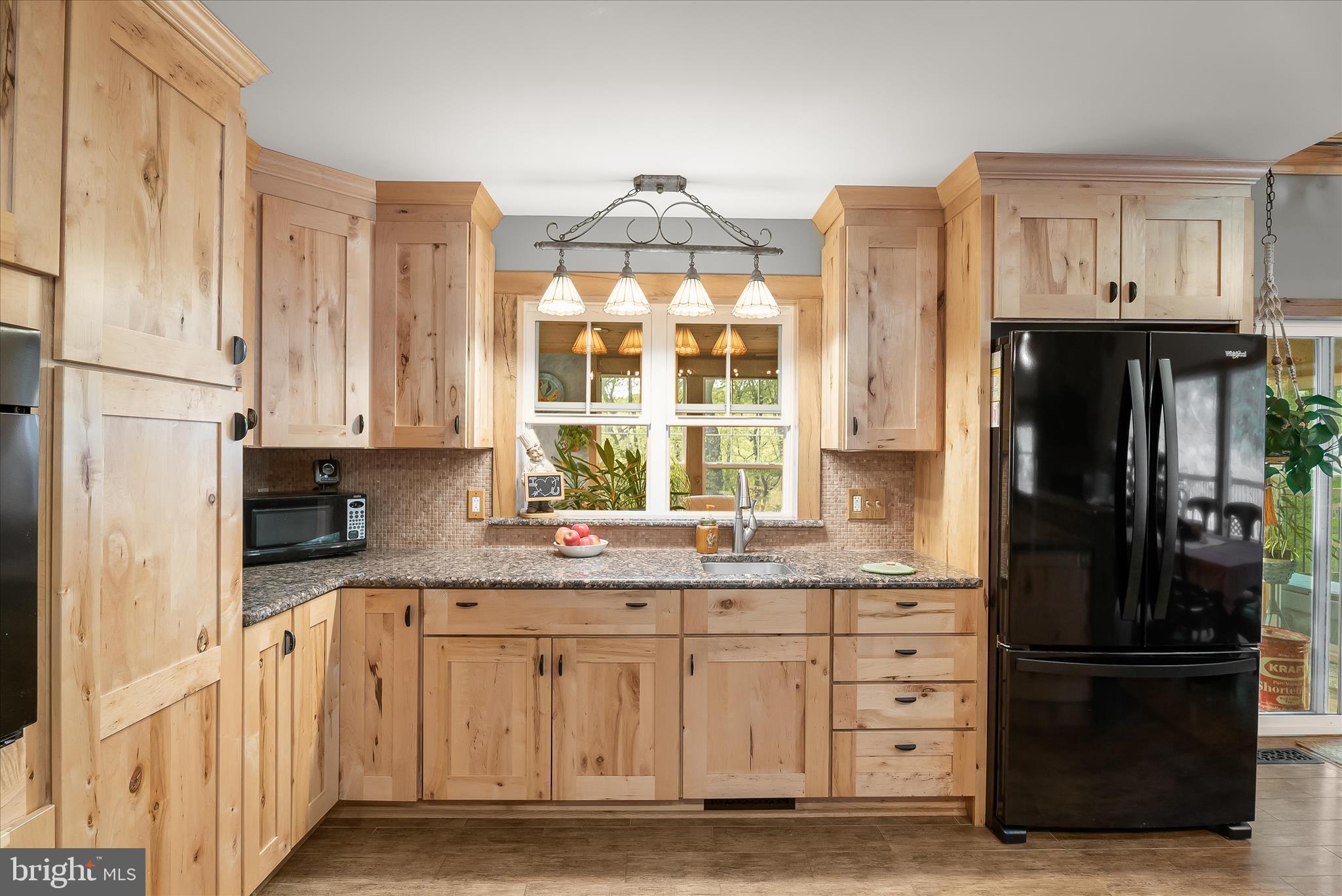 4623 Fishers Hollow Road Myersville, MD 21773 - Photo 33 of 65 a kitchen with granite countertop a refrigerator and a sink