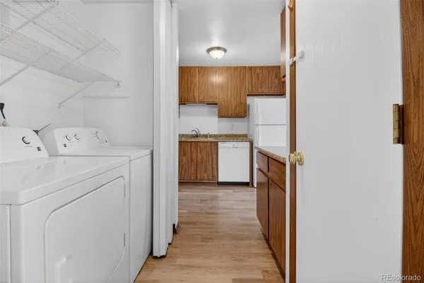 a kitchen with granite countertop cabinets stainless steel appliances and a wooden floor