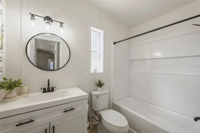 a bathroom with a sink a mirror and a toilet