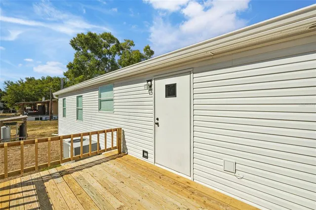a view of a balcony with wooden floor and fence