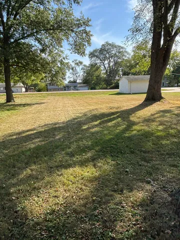 a view of a field with an ocean view