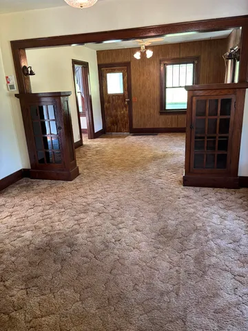 a view of an empty room with closet and a fireplace