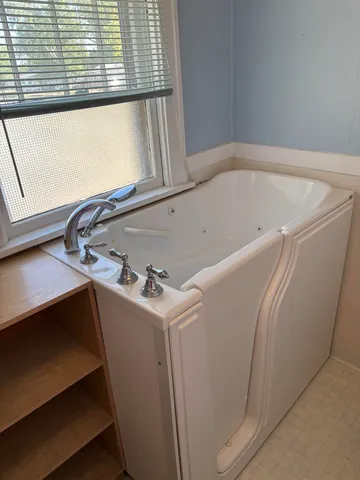 a view of an empty room with a mirror