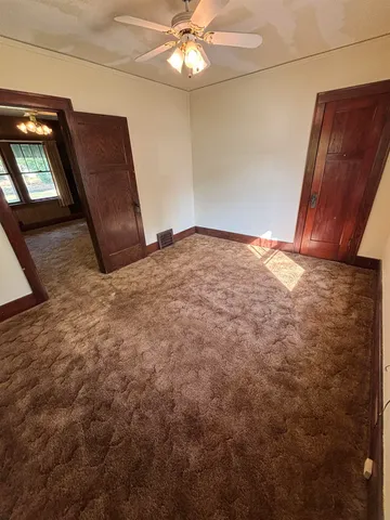 a view of a livingroom with a ceiling fan and bathroom