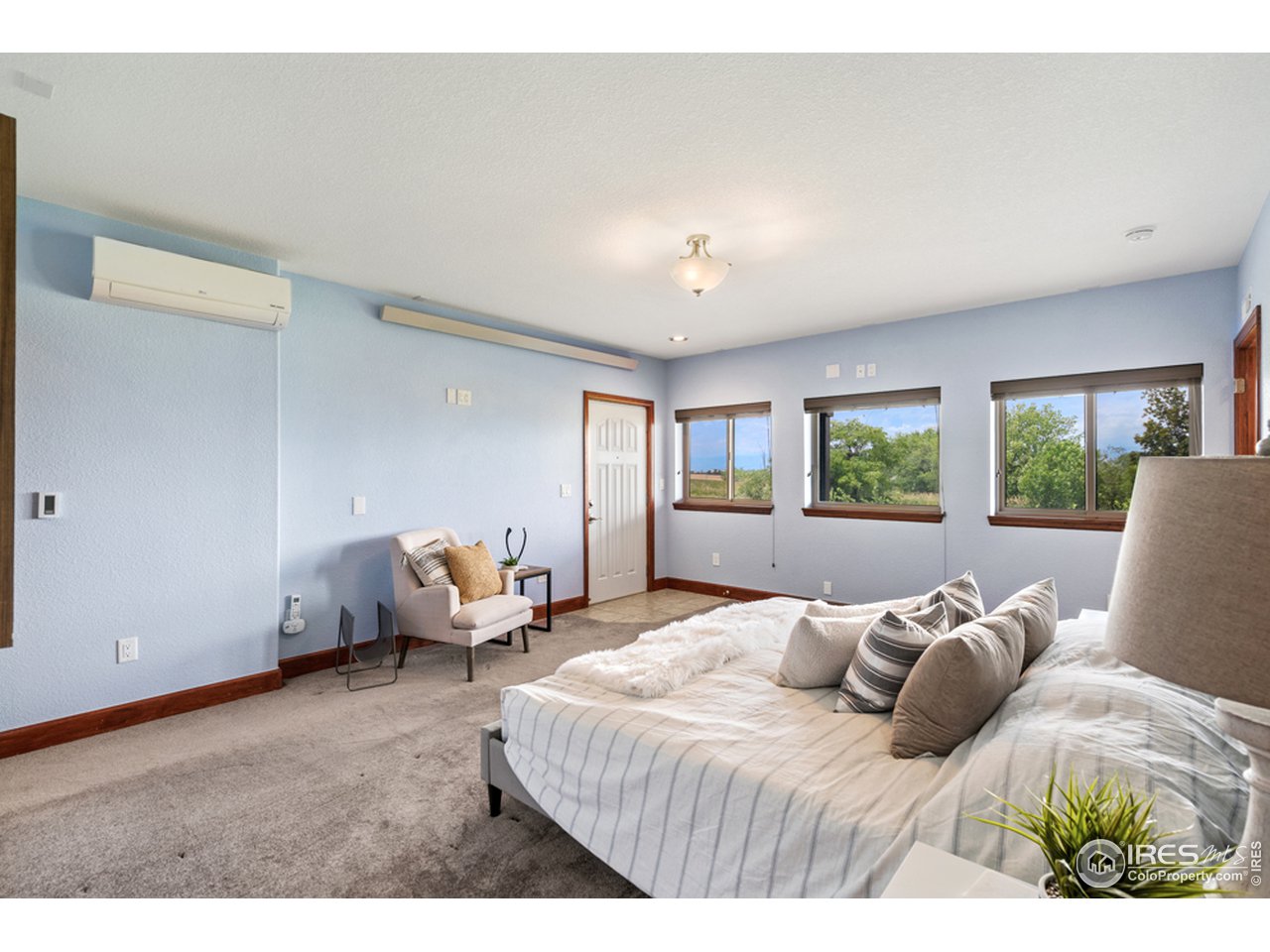 17622 County Road 1 Berthoud, CO 80513 - Photo 27 of 40 a bedroom with a bed and wooden floor