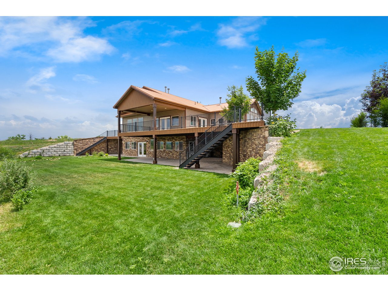 17622 County Road 1 Berthoud, CO 80513 - Photo 8 of 40 a front view of a house with garden