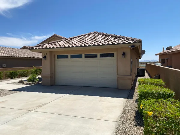 a kitchen with stainless steel appliances granite countertop wooden cabinets a stove a sink and dishwasher with wooden floor