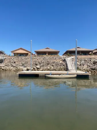 a kitchen with stainless steel appliances granite countertop a sink dishwasher stove and wooden cabinets