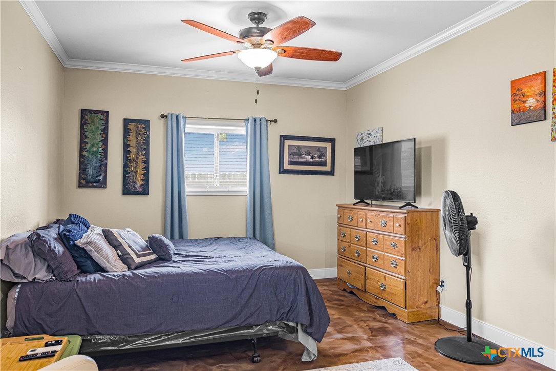 254 Sendera Loop Victoria, TX 77904 - Photo 46 of 48 a bedroom with a bed and a flat screen tv
