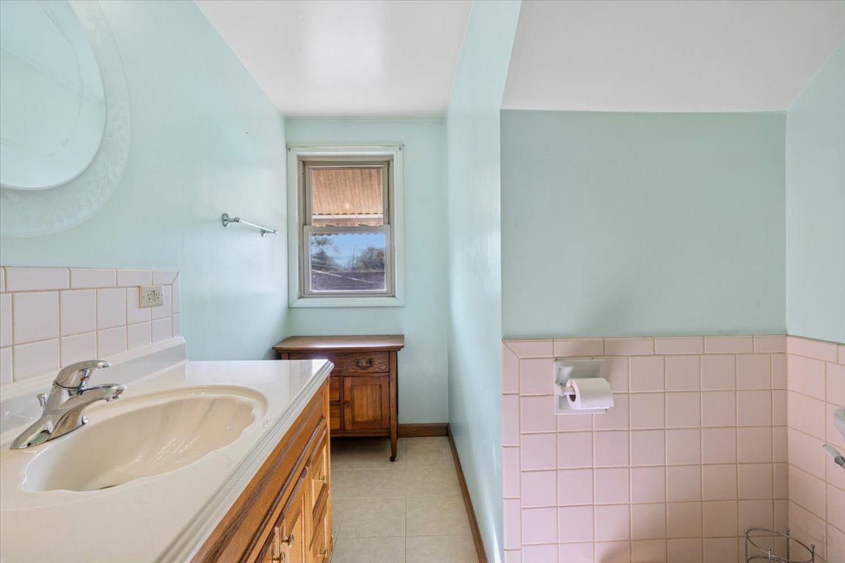 7841 44th Street Lyons, IL 60534 - Photo 16 of 23 a bathroom with a sink and a bathtub