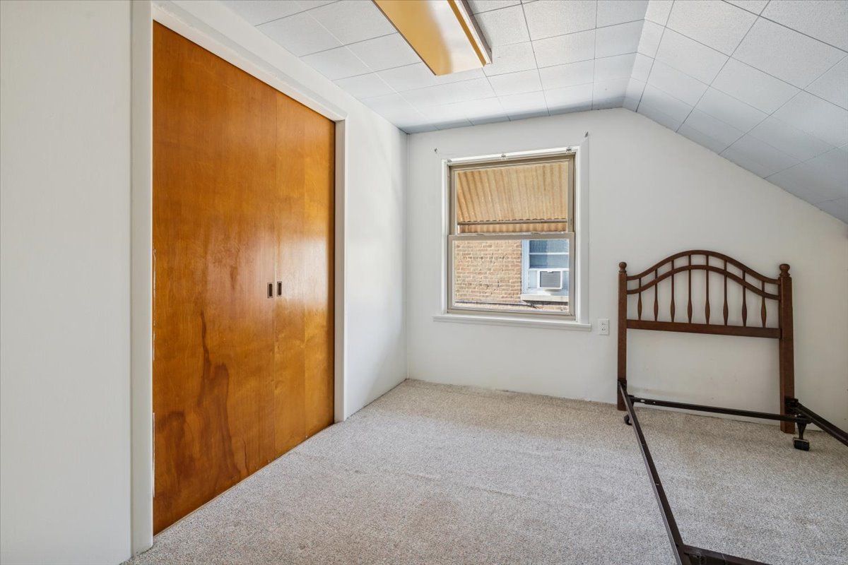 7841 44th Street Lyons, IL 60534 - Photo 17 of 23 a view of an empty room with window and closet