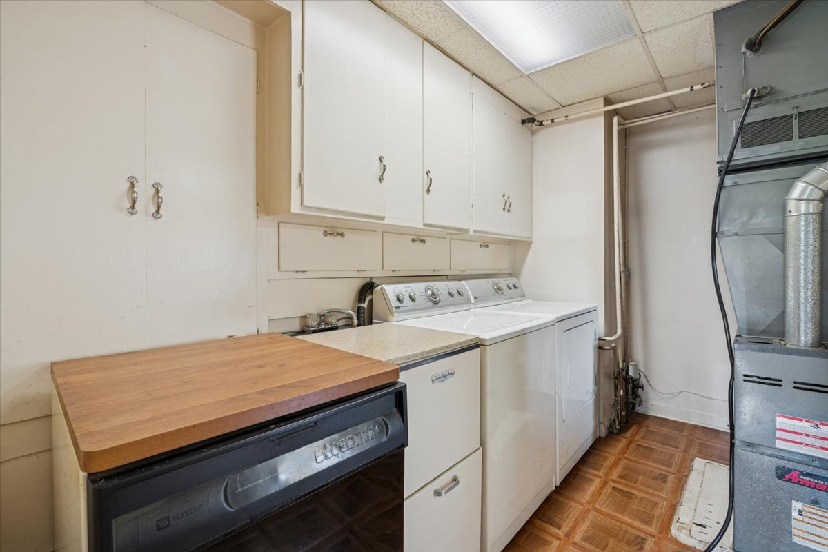 7841 44th Street Lyons, IL 60534 - Photo 18 of 23 a utility room with cabinets washer and dryer