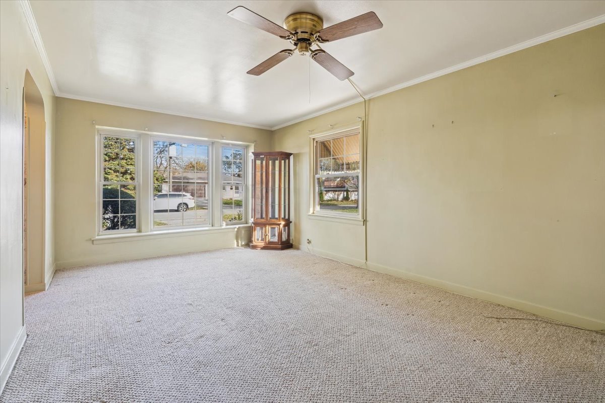 7841 44th Street Lyons, IL 60534 - Photo 3 of 23 an empty room with windows and ceiling fan view