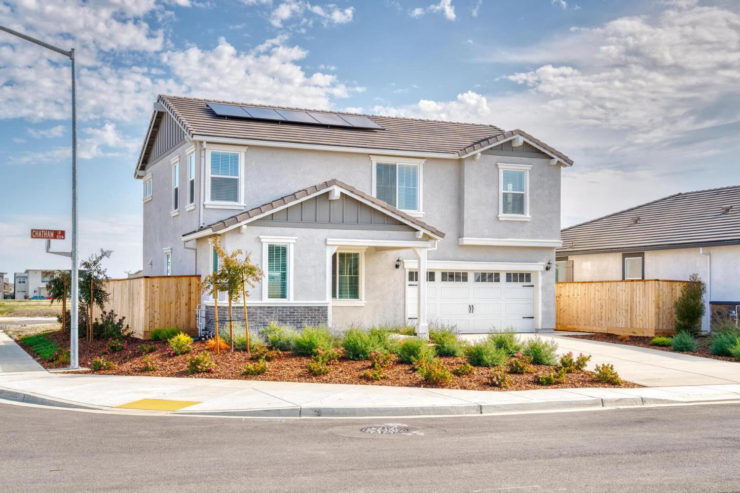 820 Chatham Lane Patterson, CA 95363 - Photo 1 of 19 a front view of a house with a garden