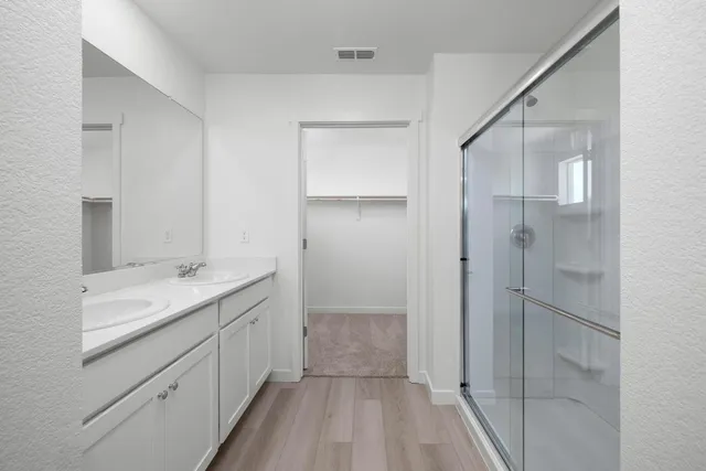 a bathroom with a shower sink and mirror
