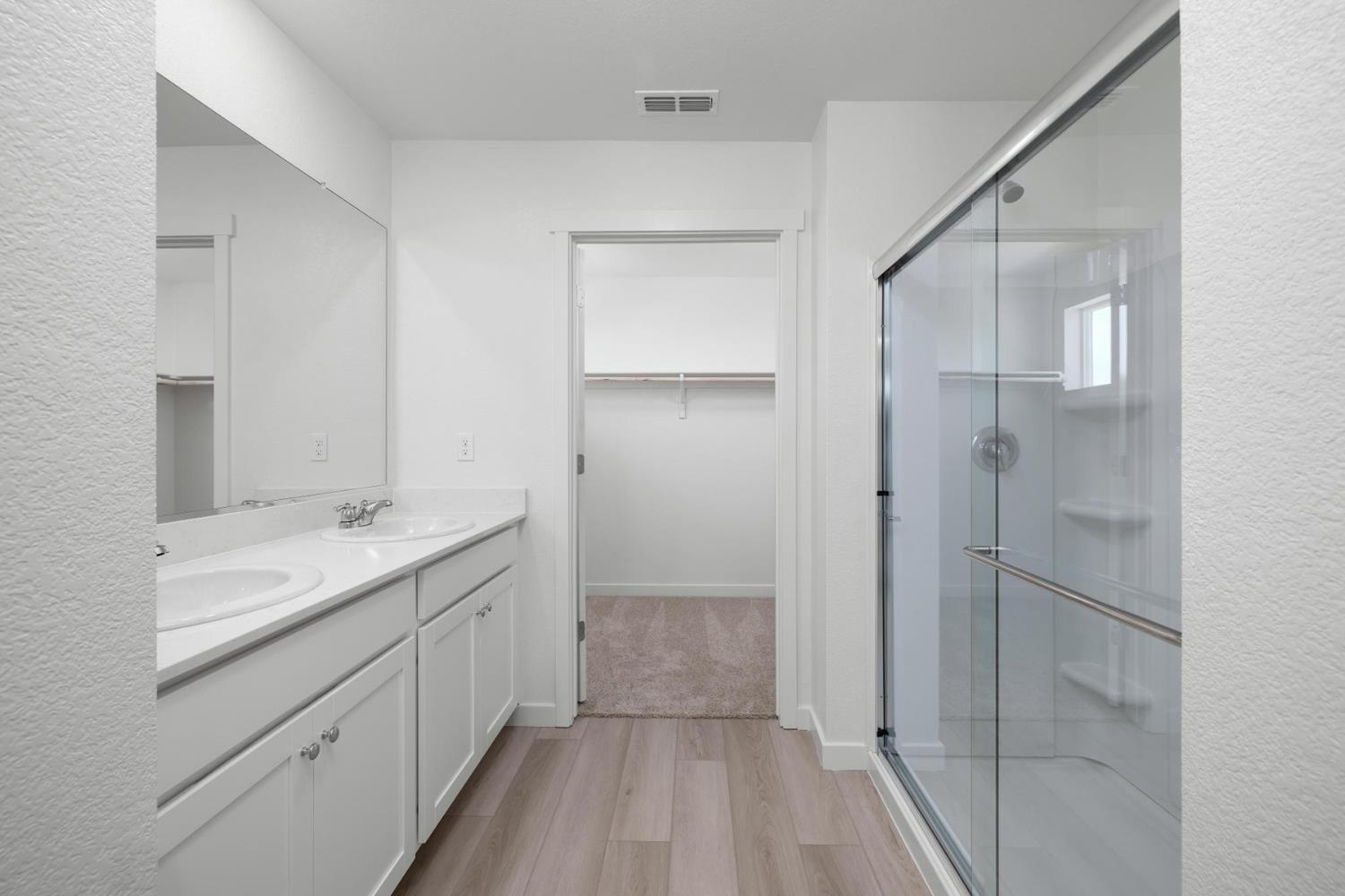 820 Chatham Lane Patterson, CA 95363 - Photo 11 of 19 a bathroom with a shower sink and mirror