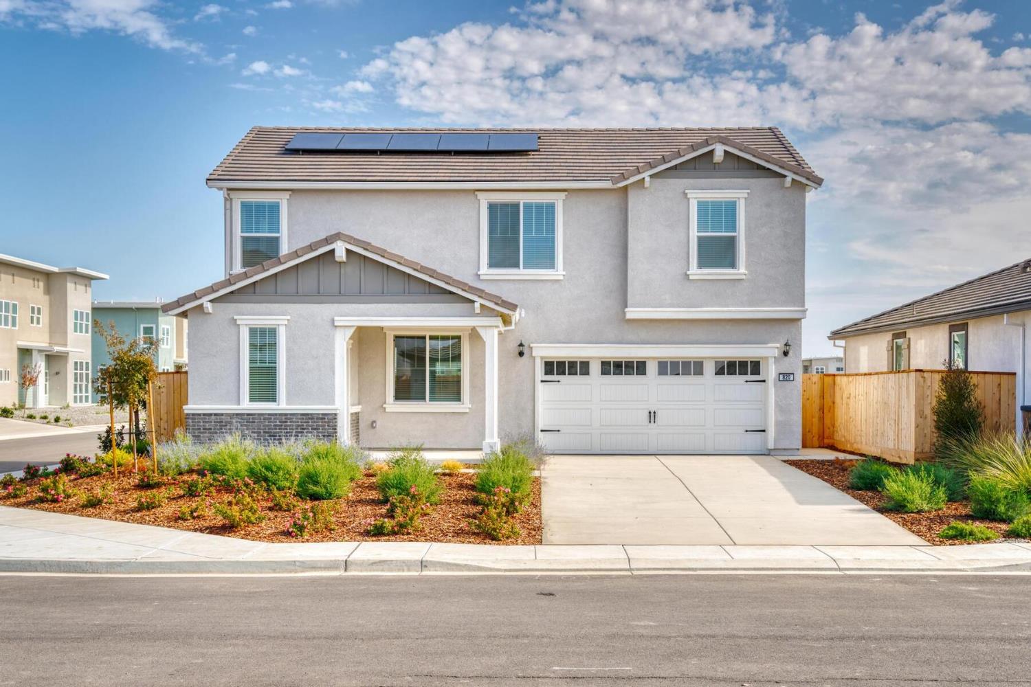 820 Chatham Lane Patterson, CA 95363 - Photo 2 of 19 a front view of a house with a yard and potted plants