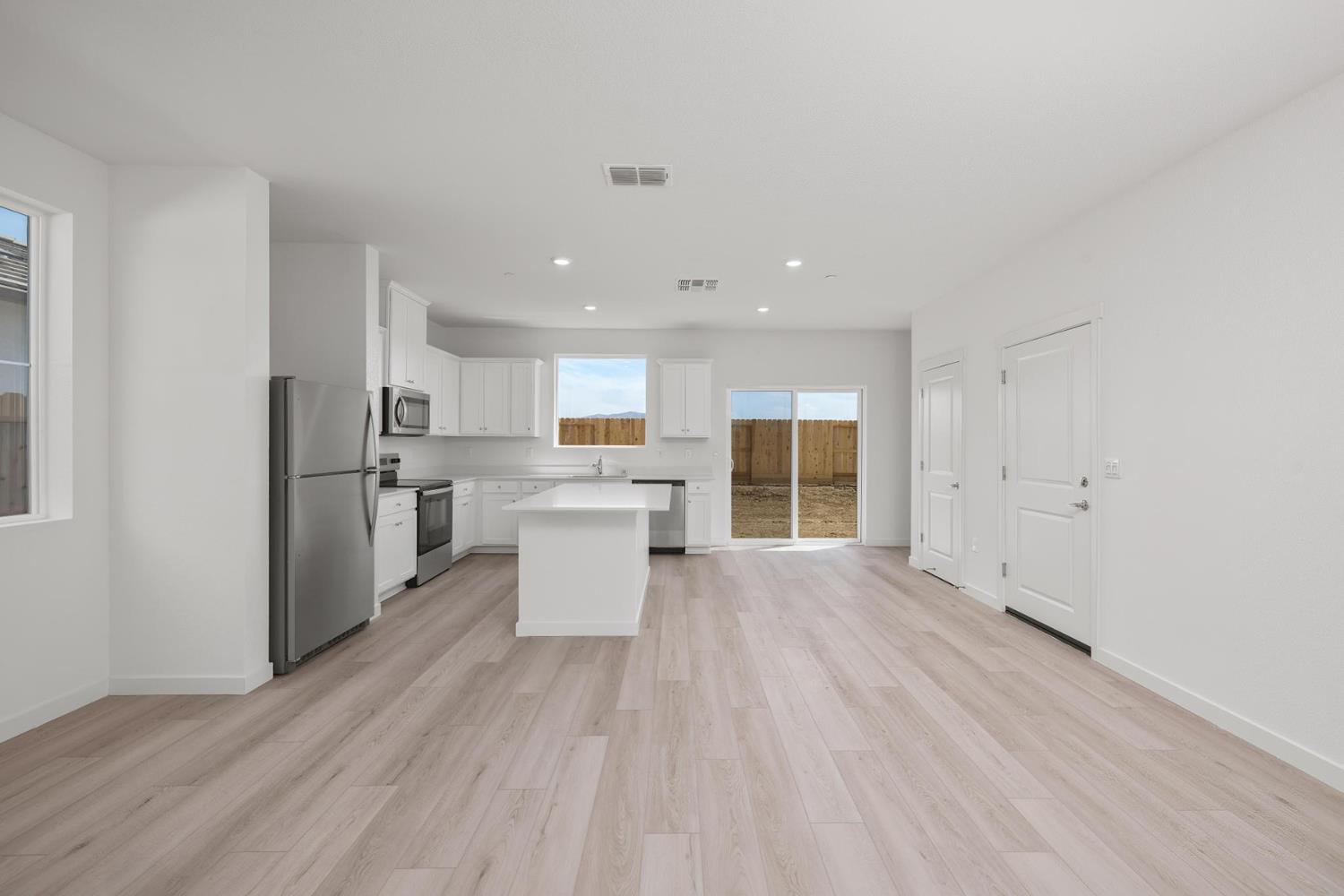 820 Chatham Lane Patterson, CA 95363 - Photo 3 of 19 a open kitchen with white cabinets and wooden floor