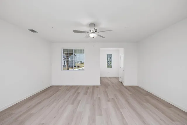 wooden floor in an empty room with a window