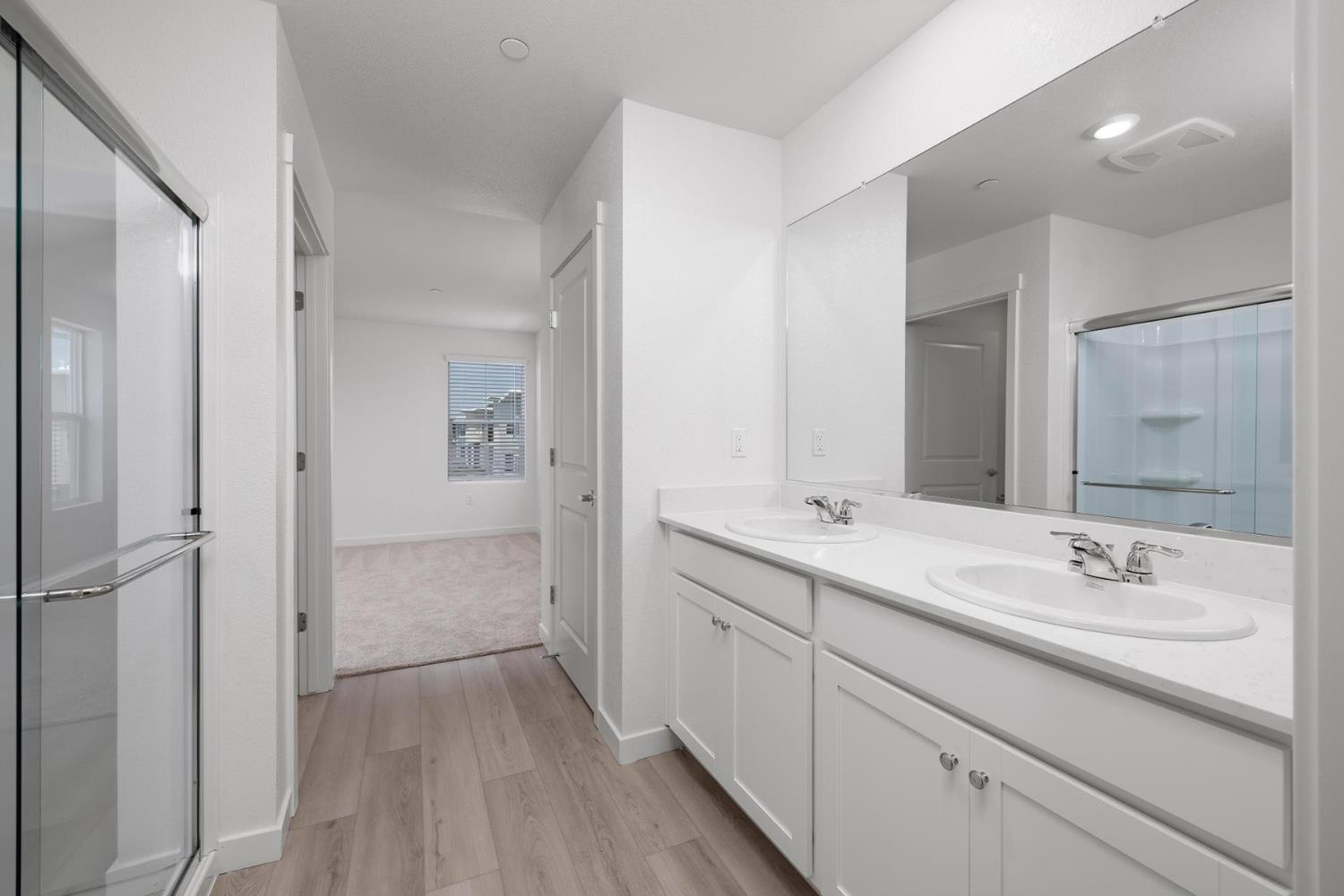 820 Chatham Lane Patterson, CA 95363 - Photo 10 of 19 a bathroom with a double vanity sink mirror and shower