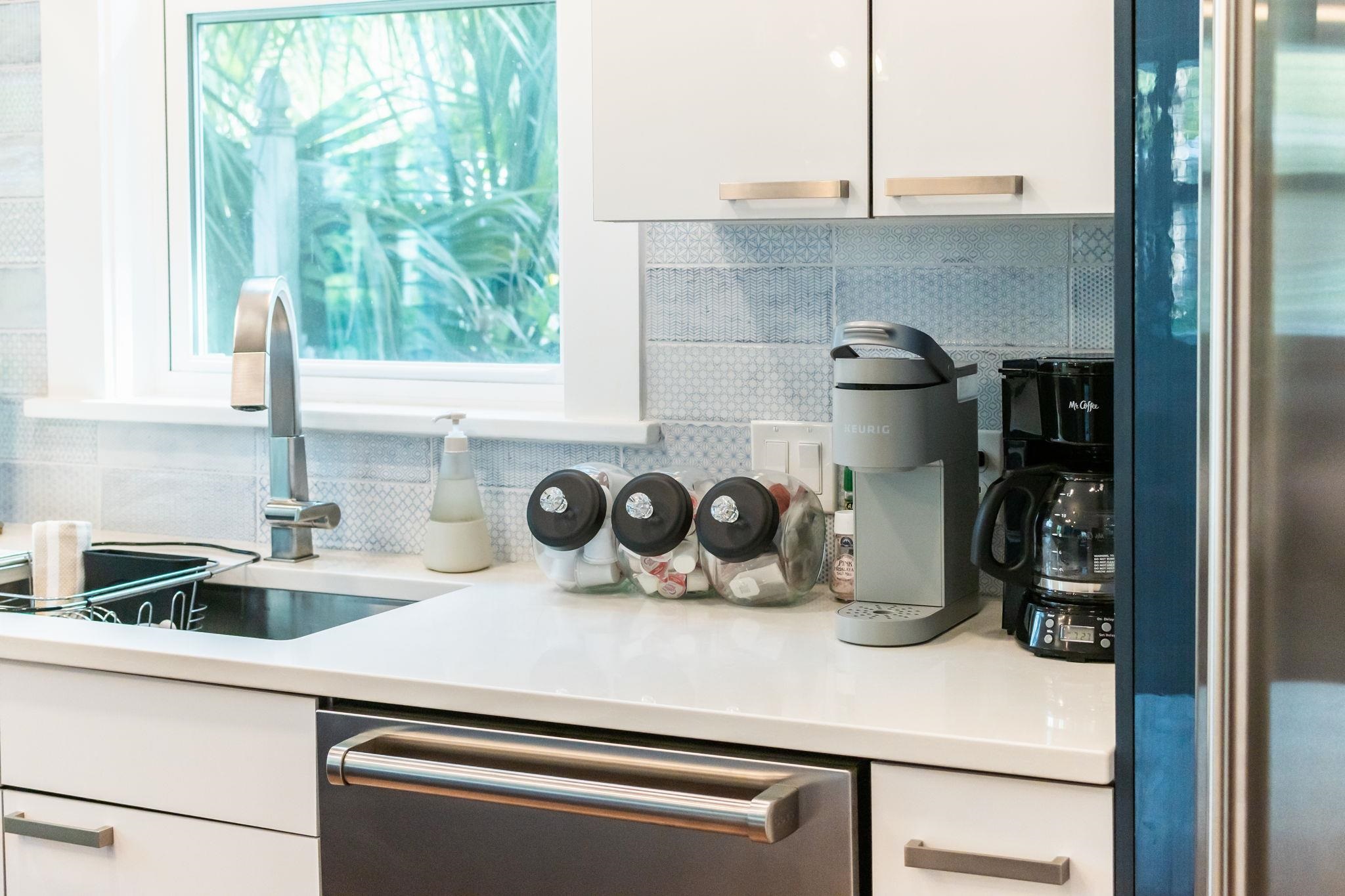21 Saragossa Street St. Augustine, FL 32084 - Photo 21 of 66 Kitchen featuring white cabinets, stainless steel appliances, and decorative backsplash