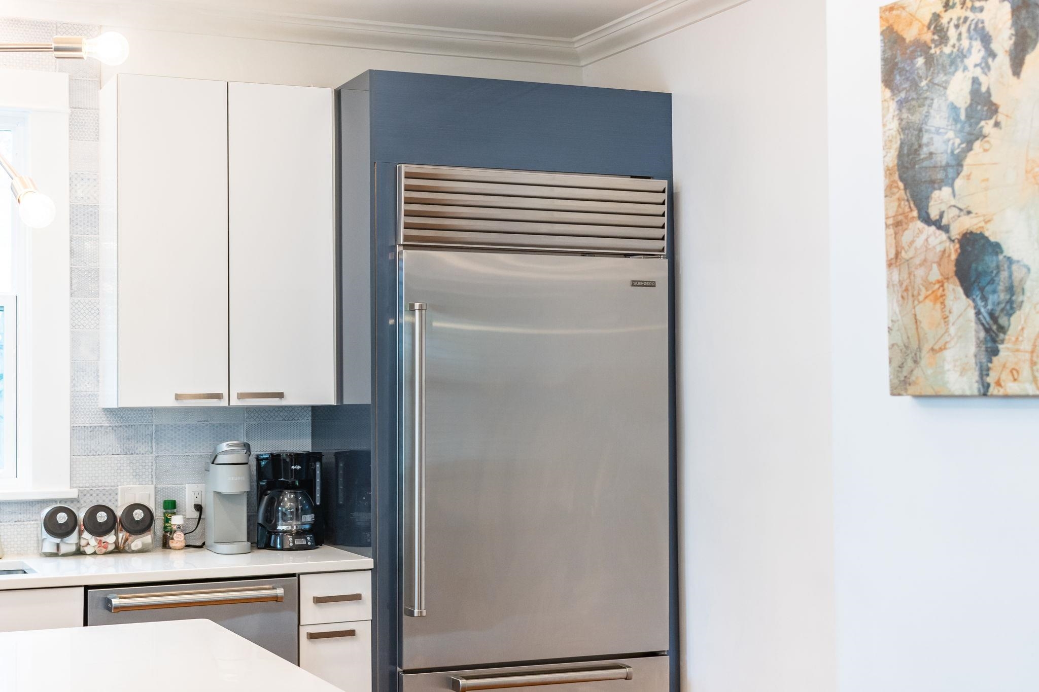 21 Saragossa Street St. Augustine, FL 32084 - Photo 3 of 66 Kitchen with stainless steel appliances, white cabinets, crown molding, and decorative backsplash
