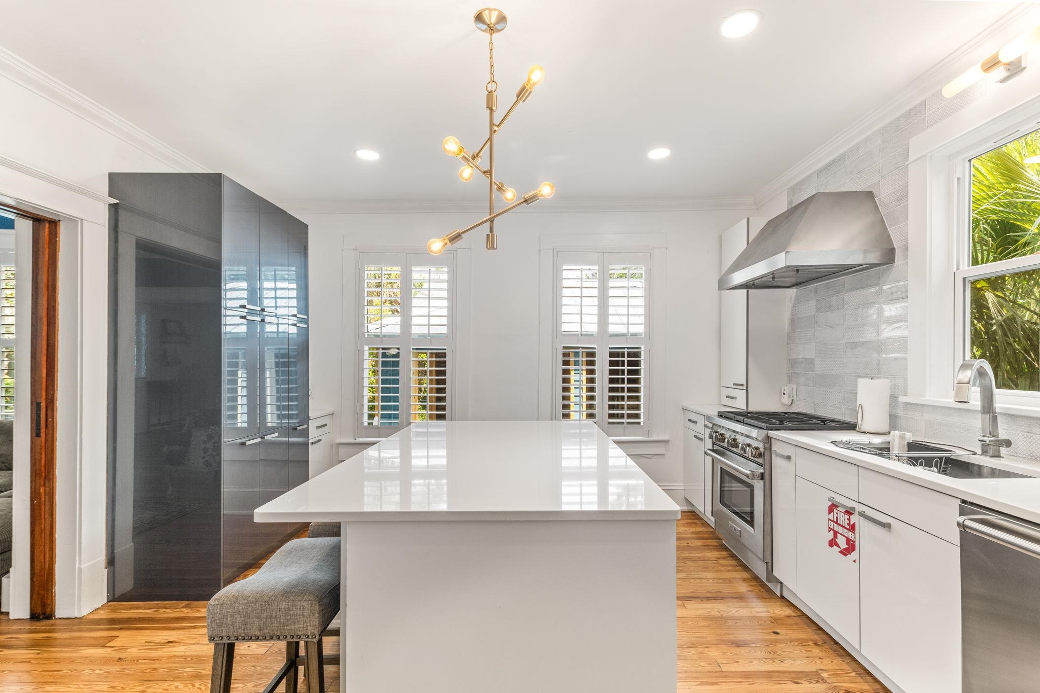 21 Saragossa Street St. Augustine, FL 32084 - Photo 31 of 66 Kitchen featuring a center island, stainless steel appliances, healthy amount of natural light, a kitchen bar, and ornamental molding