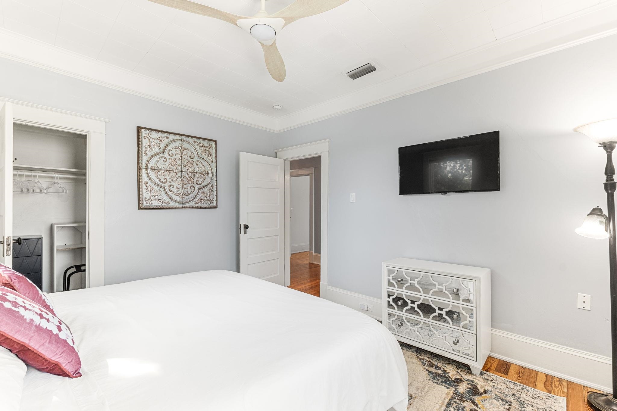 21 Saragossa Street St. Augustine, FL 32084 - Photo 65 of 66 Bedroom featuring wood finished floors, ornamental molding, a ceiling fan, and a closet