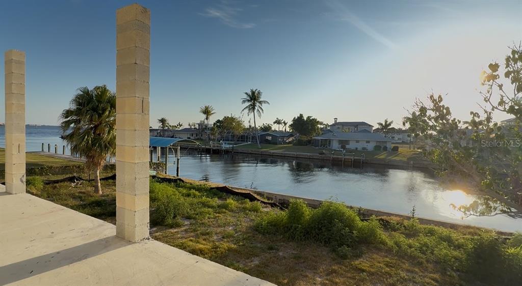 242 Bangsberg Road Southeast Port Charlotte, FL 33952 - Photo 2 of 18 a view of a lake with boats