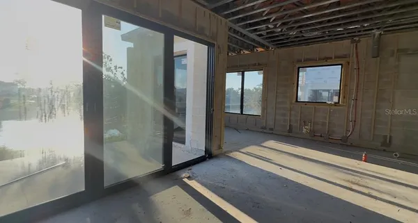 a view of a room with wooden floor and windows