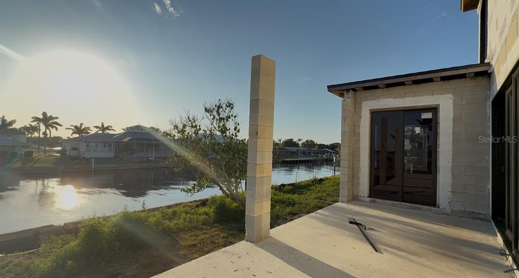 242 Bangsberg Road Southeast Port Charlotte, FL 33952 - Photo 10 of 18 a balcony with view of lake and mountain view