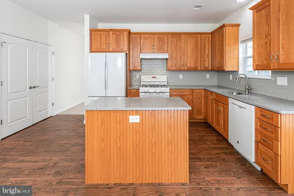 a kitchen with stainless steel appliances a refrigerator sink and cabinets
