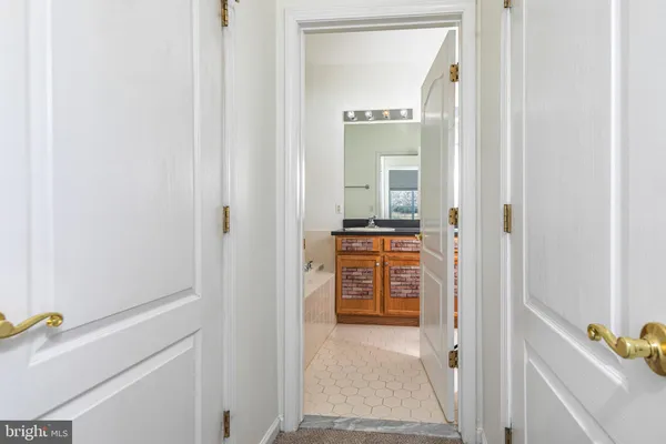 a view of walk in closet with clothes