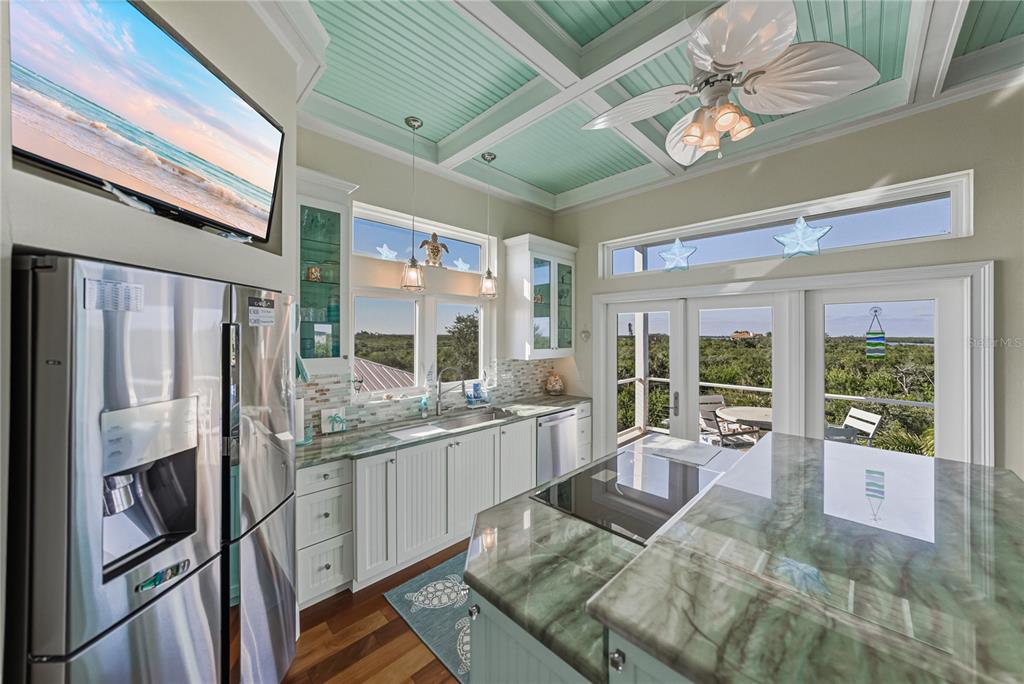 125 Burns Road Terra Ceia, FL 34250 - Photo 19 of 90 a living room with stainless steel appliances granite countertop furniture a fireplace and a large window