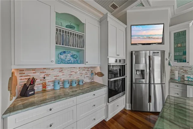 a bathroom with a granite countertop sink a mirror and a window