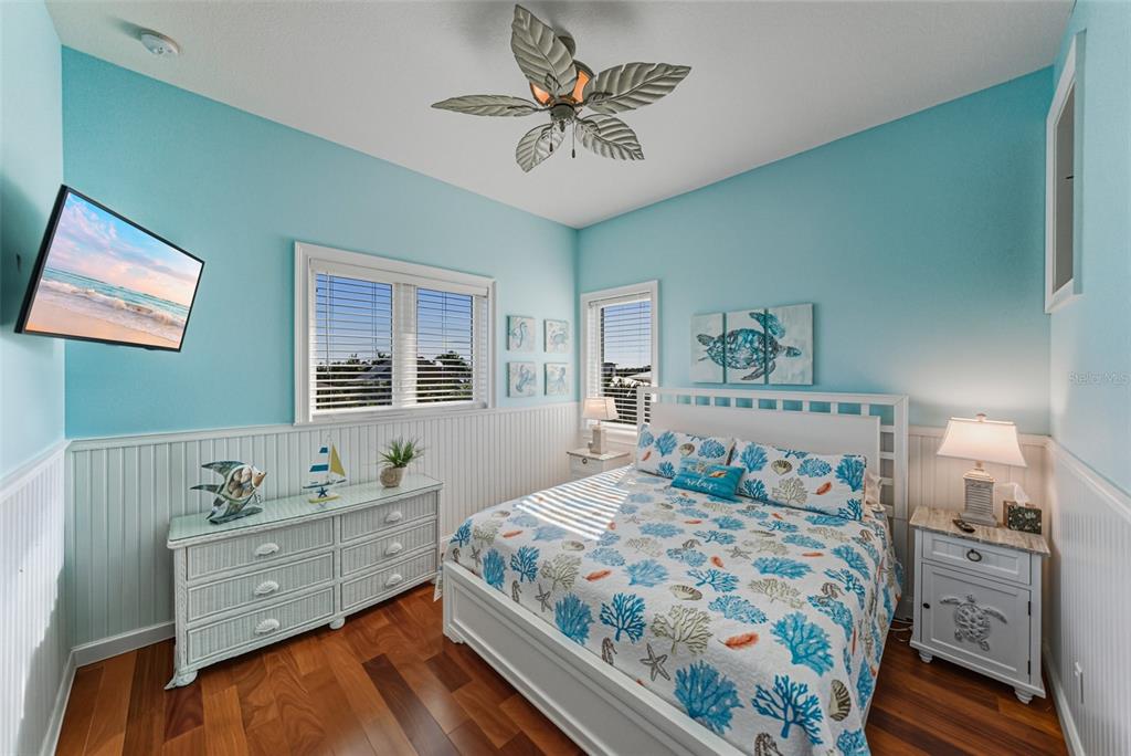125 Burns Road Terra Ceia, FL 34250 - Photo 26 of 90 a bedroom with a bed and a chandelier