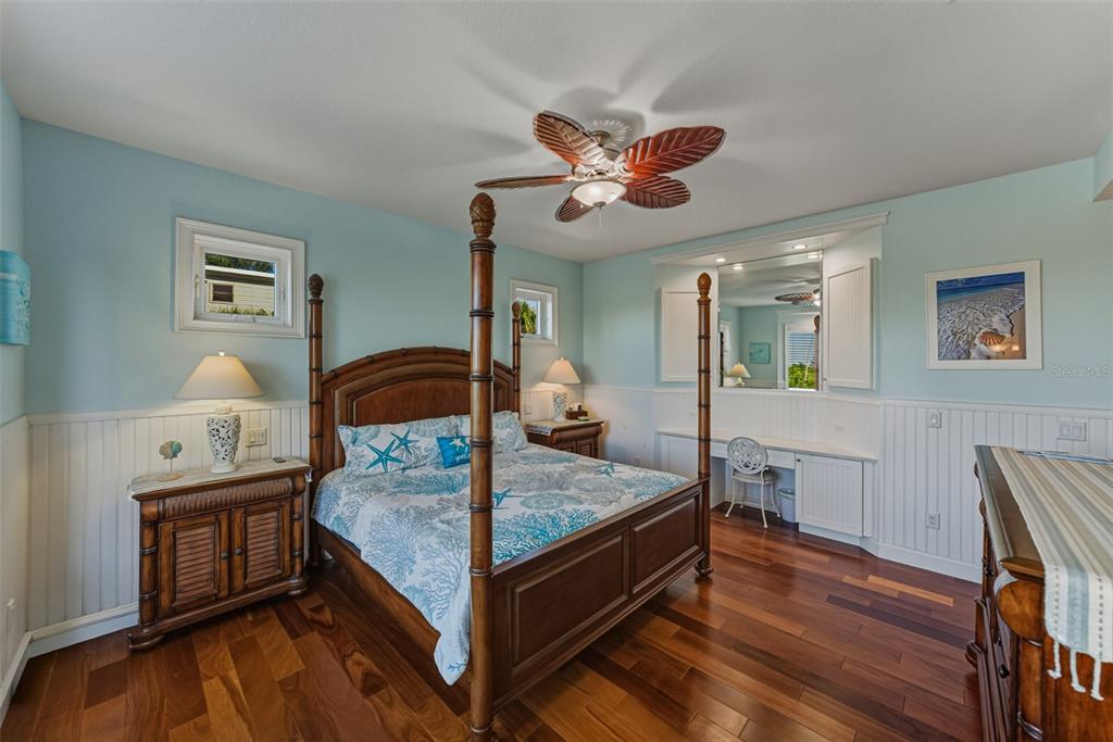 125 Burns Road Terra Ceia, FL 34250 - Photo 27 of 90 a bedroom with a bed and wooden floor