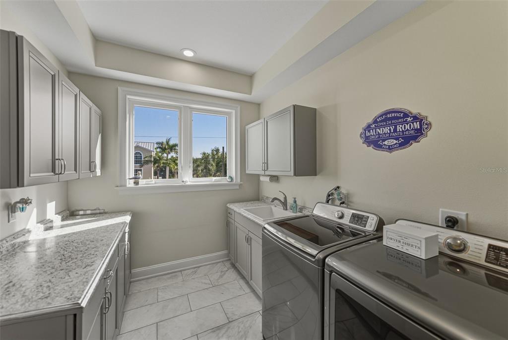 125 Burns Road Terra Ceia, FL 34250 - Photo 34 of 90 a bathroom with a granite countertop sink a mirror and a window