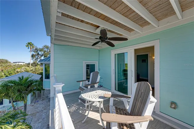a view of a porch with furniture and wooden floor