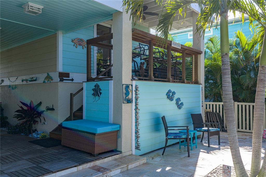 125 Burns Road Terra Ceia, FL 34250 - Photo 41 of 90 a view of a deck with a table and chairs and potted plants