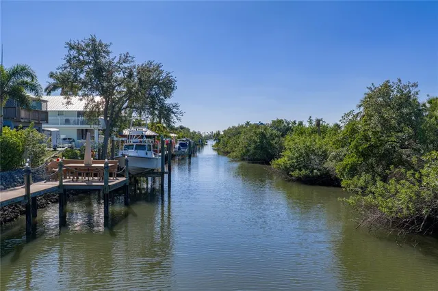 a living room with furniture a large window and wooden floor