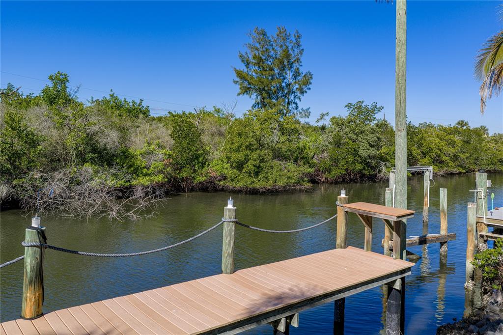 125 Burns Road Terra Ceia, FL 34250 - Photo 63 of 90 a view of a balcony with two chairs and a table