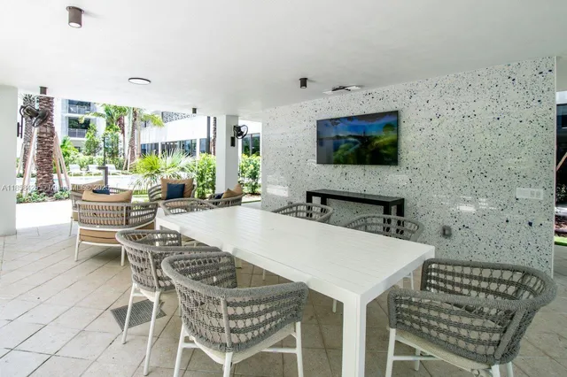 a kitchen with stainless steel appliances granite countertop a stove a sink and a white cabinets