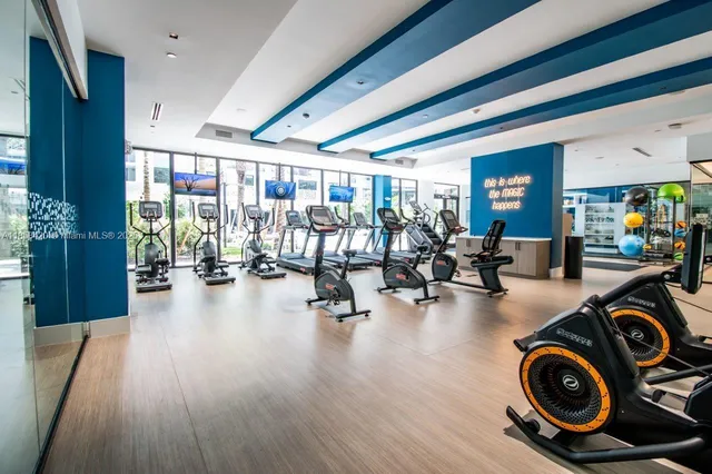 a living room filled with furniture and a floor to ceiling window