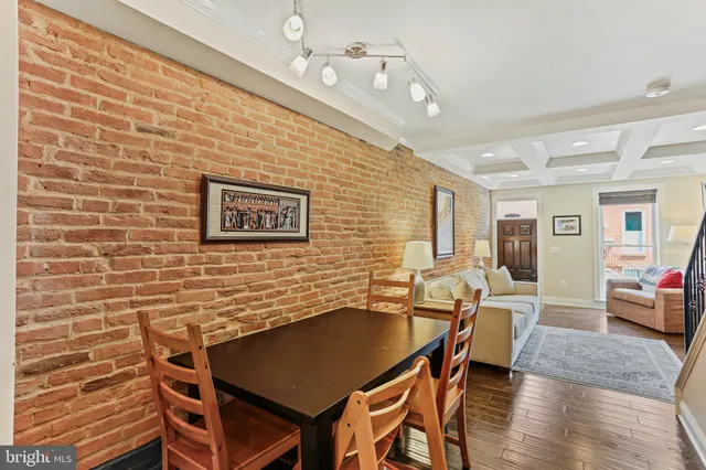 a dining room with a wooden table and chairs