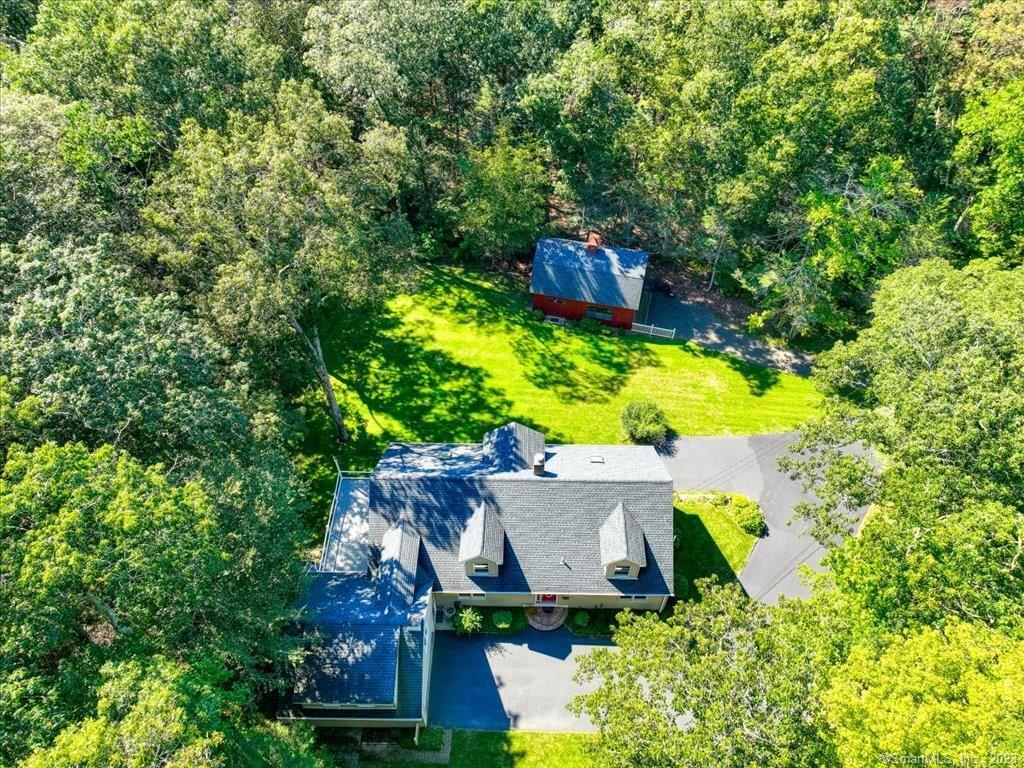 an aerial view of a house with a yard