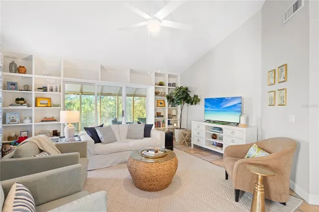 a living room with fireplace furniture and a flat screen tv