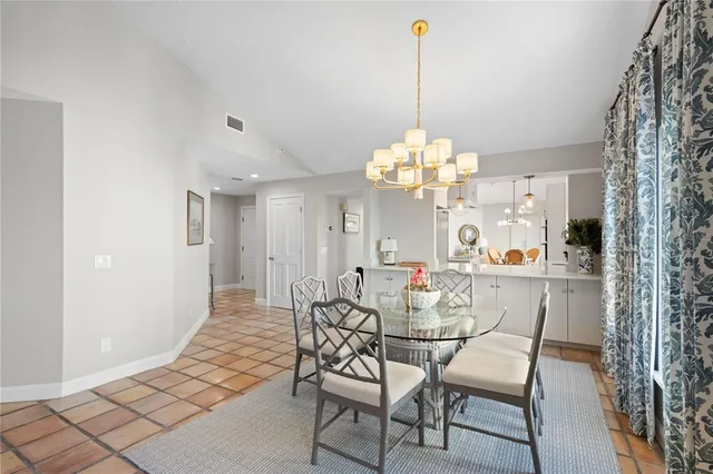 a view of a dining room with furniture and chandelier