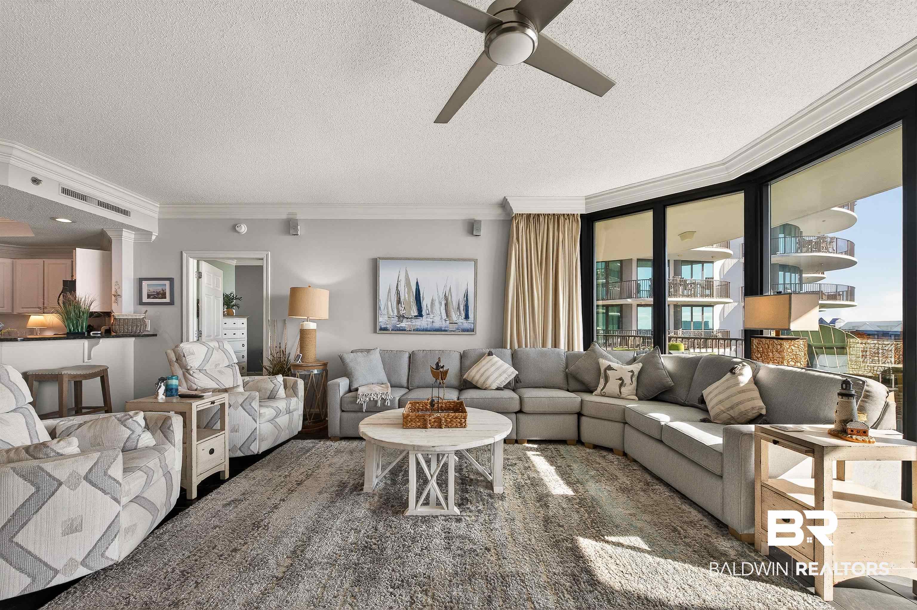 27582 Canal Road, Unit 2507 Orange Beach, AL 36561 - Photo 11 of 75 Living room featuring crown molding, a textured ceiling, and a ceiling fan